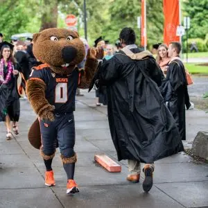 Benny high-fiving a graduating student